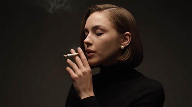 Young Brunette Woman In Black Turtleneck Smoking Cigarette With Dark Background And Soft Lighting Elegant Pearl Earrings