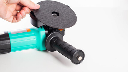 Installing a cutting disc on an angle grinder. White background. copy space for text, industrial