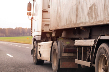 White heavy duty semi truck driving on asphalt road during day. Large commercial vehicle transport...