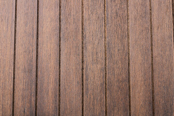 A uniform background of rich, reddish-brown vertical wood planks. The clean lines and subtle grain texture provide a warm, classic, and natural aesthetic.