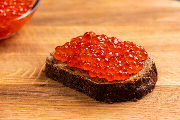 Red Salmon Roe (Ikura) sandwich with red caviar on Black Background