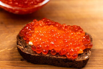 Red Salmon Roe (Ikura) sandwich with red caviar on Black Background