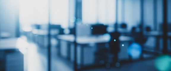 Blurred modern office interior with bright light and blue tones, enhanced by soft reflections and subtle depth that create a calm professional atmosphere suitable for corporate visuals.