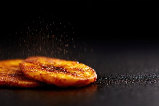 Golden plantain slices glisten with spices, showcasing rich flav