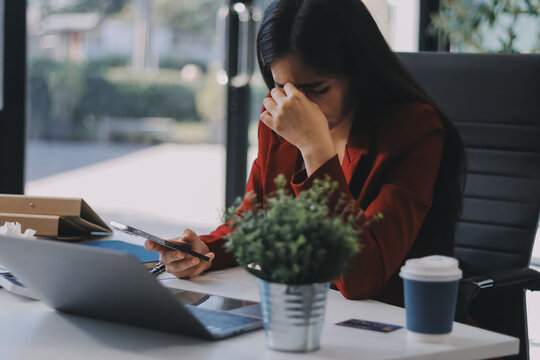 tired business woman sleepy and bored from sitting at a desk for a long time and has office syndrome