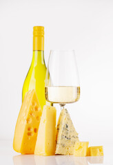 Naklejka premium Assorted cheeses and wine on white background