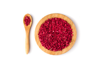 dried raspberries and a spoon with raspberries on a white background