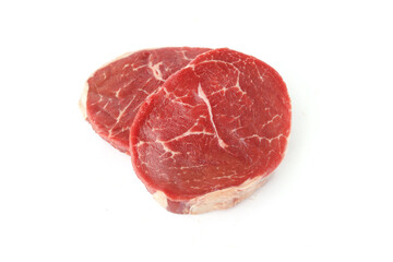 raw pieces of beef on a white background
