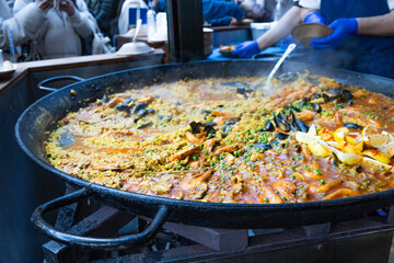 Traditional Spanish Seafood Paella Cooking in Large Pan at Street Market