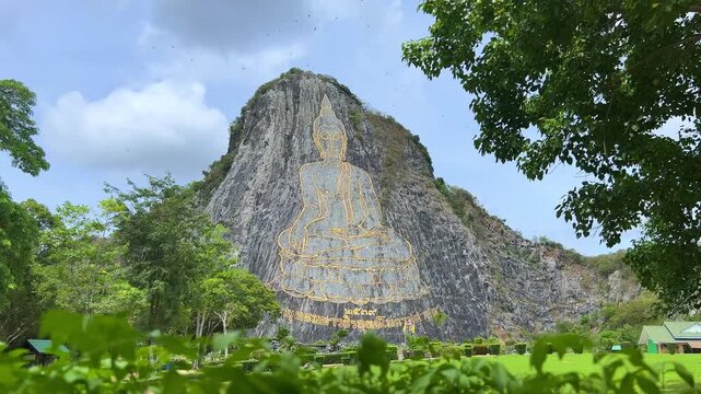 CHONBURI, Thailand - June 9, 2025: The Golden Buddha Mountain. The Buddha image carved into the rock of Khao Chi Chan, Khao Chion, Pattaya, engraved in gold,on a hill dedicated to His Majesty the King