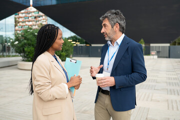 Diverse business colleagues talking during city coffee break