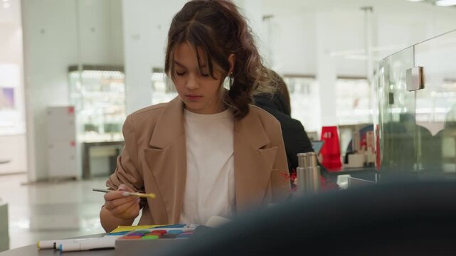woman organizing stickers, calm woman arranging vibrant stickers in retail space, patient woman carefully placing colorful notes and stickers into systematic layout in mall environment