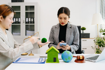 A lawyer presenting a green house model and earth globe with a gavel showing environmental law eco policy sustainability justice and global