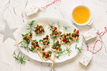 Camembert appetizer Christmas trees with nuts, pomegranate, and parsley