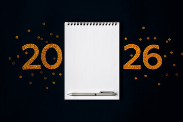 2026 New Year concept with empty notebook for your goals, plans, resolutions. Flat lay style. Christmas planning concept with space for text
