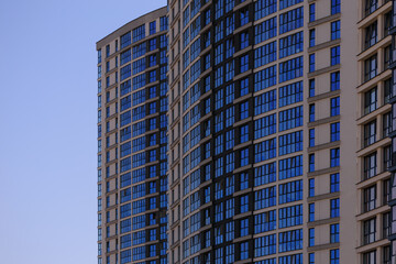 Obraz premium Cityscape on a summer day, modern buildings and houses against the blue sky 