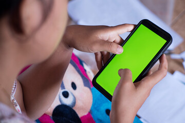 Educational Chaos: Girl Holding Smartphone on Messy Floor