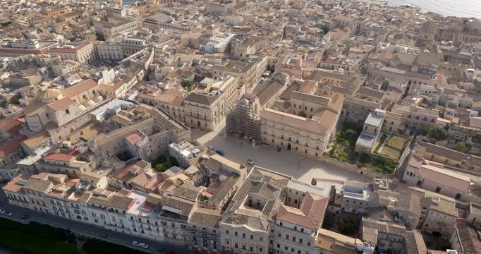 Aerial view of the Cathedral of Syracuse, formally Metropolitan Cathedral of the Nativity of the Blessed Virgin Mary. It's located in the center of the city, on the island of Ortygia, Sicily, Italy.