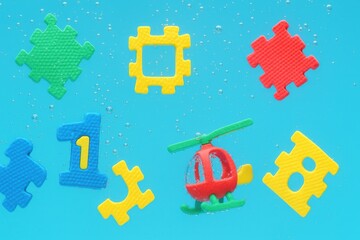 Vibrant bath time fun with floating puzzles numbers and a toy helicopter