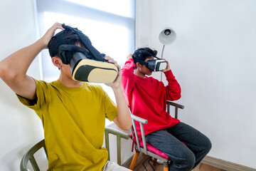 Virtual Reality Immersion Two Young Asian Men Explore Digital Worlds With VR Headsets