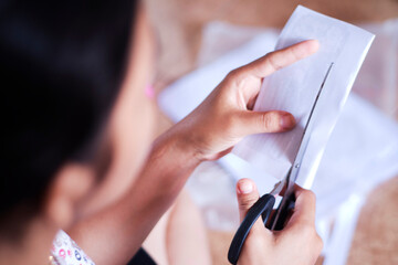 Child Cutting Paper for Homework Craft Activity