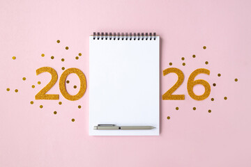 2026 New Year concept with empty notebook for your goals, plans, resolutions. Flat lay style. Christmas planning concept with space for text
