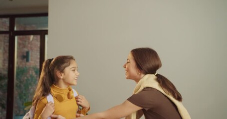 Caring mother offers encouragement in cheerful kitchen scene