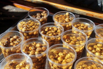 Detail of several cups containing a tasty portion of tiger nuts, put on sale at a street stand