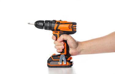 Adult hand holding orange and black cordless drill with battery attached and metal belt clip...
