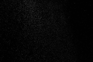 The falling white snow on a black background