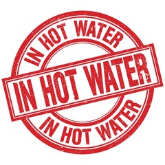 IN HOT WATER written word on red stamp sign