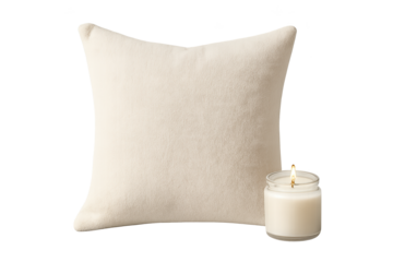 Creamy beige square pillow with small lit candle