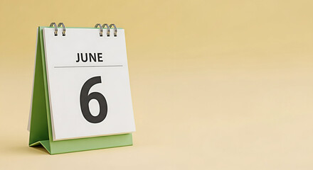 June 6th date on a desk calendar against a soft yellow background perfect for reminders scheduling and event planning showcasing a clean and minimalist design for office or personal use