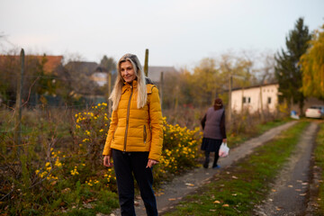 Fototapeta premium Middle-aged woman visits her elderly mother and walks through the garden