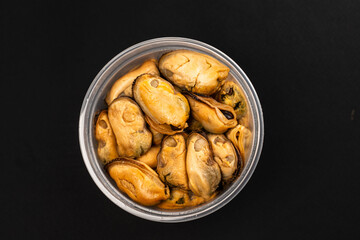 Pickled Mussels in Plastic Container on Dark Background
