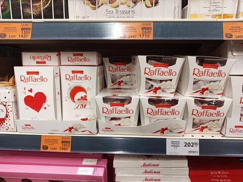 Zvyagel, Ukraine - December 02, 2025: Raffaello coconut candy boxes displayed on supermarket shelf, showcasing festive packaging and appealing design for sweet treat lovers