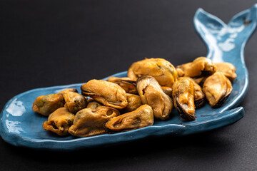 Pickled Mussels in Plastic Container on Dark Background