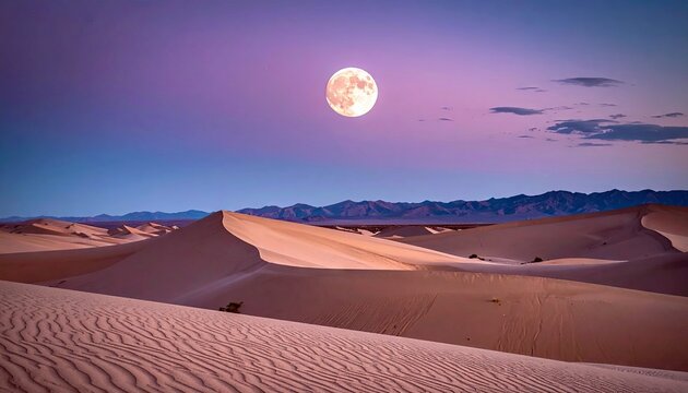 A full moon illuminates the sand dunes of a desert landscape at dusk, with a colorful sky.