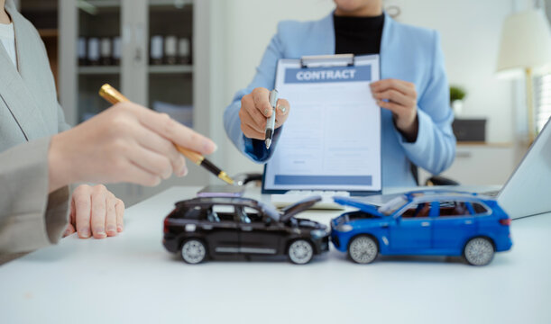 Insurance concept, insurance agent checking broken car and submit a claim form after an accident traffic accident