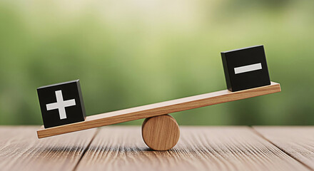 Plus and minus symbols on balancing scale representing comparison and contrast showcasing balance decisionmaking and opposites on a wooden surface with a blurred green background