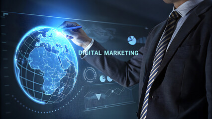 Businessman interacting with a futuristic digital interface showing a glowing blue globe and the text digital marketing for global business strategy and online promotion concept