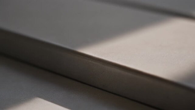 Closeup of a textured surface with diagonal light and shadow