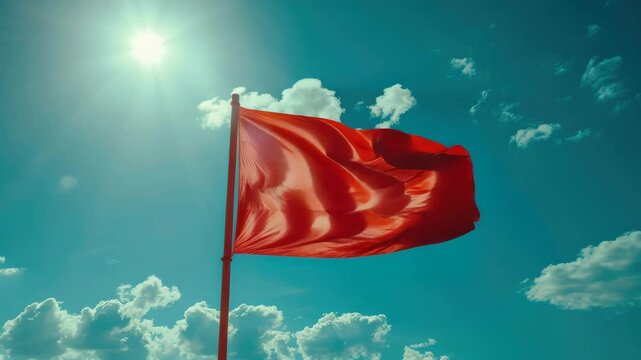 A red banner in the wind on a sunny day.