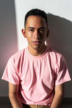 Latino man in direct sunlight expressing grounded confidence