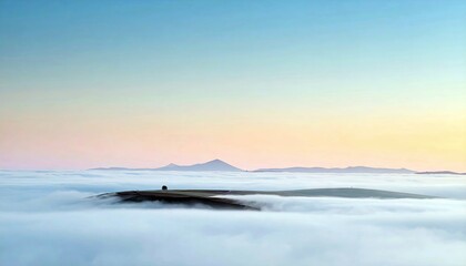 A landscape image of a hill emerging from a sea of clouds at sunrise, with a colorful sky.