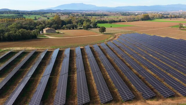 Aerial view of solar panels in a rural field