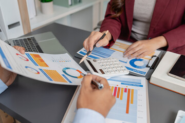 Business colleagues reviewing budget charts together in a modern office, focusing on financial insights, performance metrics, and strategic planning to support upcoming business decisions.