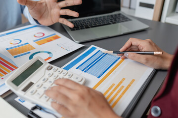 Business colleagues reviewing budget charts together in a modern office, focusing on financial insights, performance metrics, and strategic planning to support upcoming business decisions.