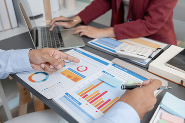 Business colleagues reviewing budget charts together in a modern office, focusing on financial insights, performance metrics, and strategic planning to support upcoming business decisions.