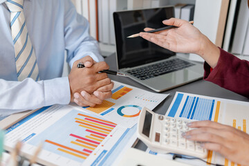 Business colleagues reviewing budget charts together in a modern office, focusing on financial insights, performance metrics, and strategic planning to support upcoming business decisions.